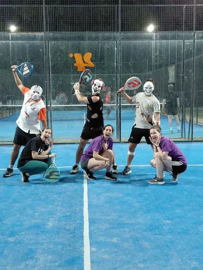 Jugadores de pádel con máscaras, posando en la cancha en un torneo de Halloween.